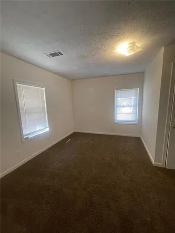 a view of room and hall with a window