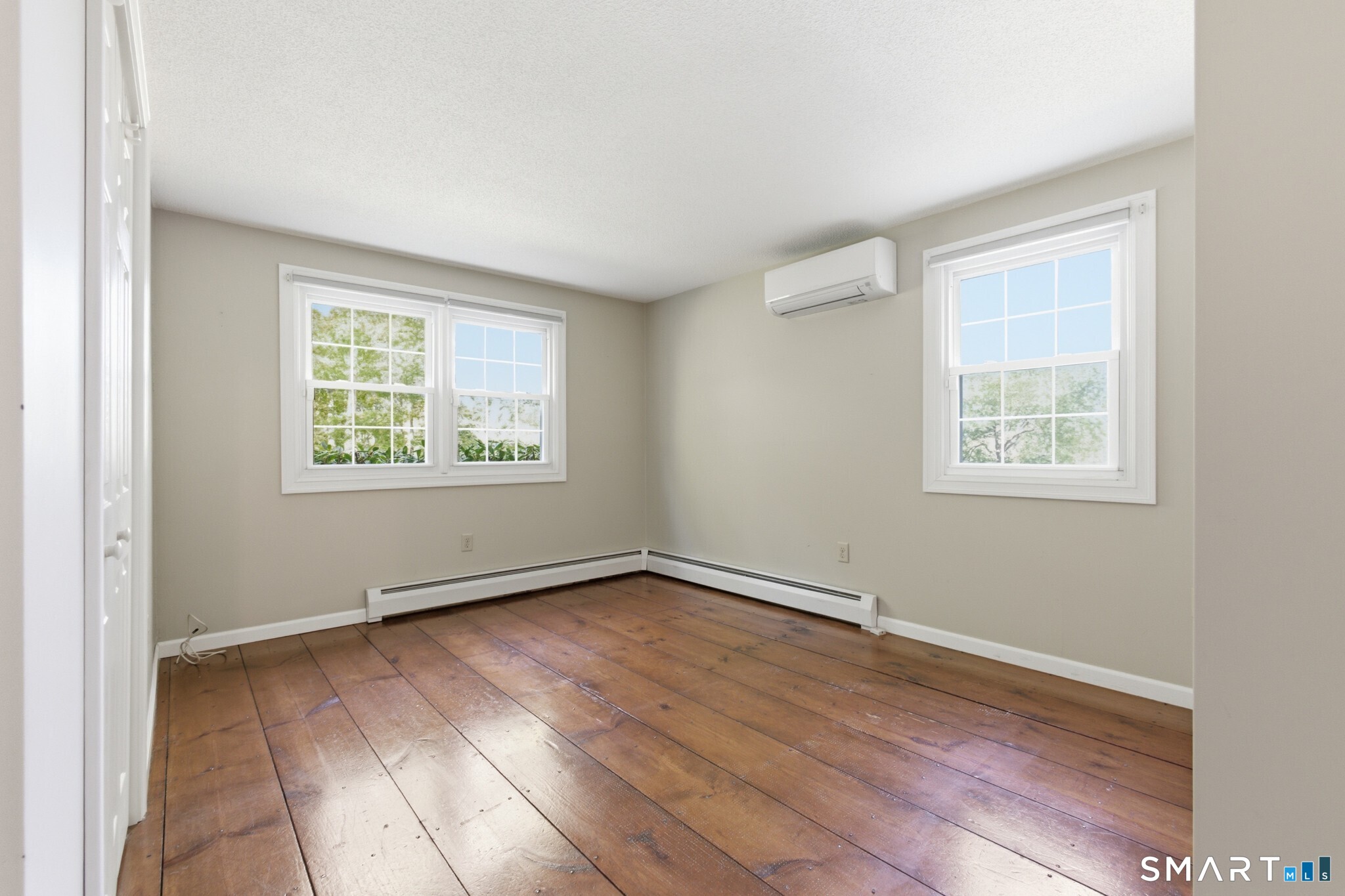 70 Mahoney Road Colchester, CT 06415 - Photo 15 of 40 an empty room with wooden floor and windows