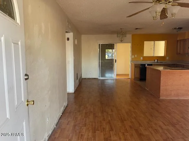 a view of a kitchen with a sink cabinets and wooden floor