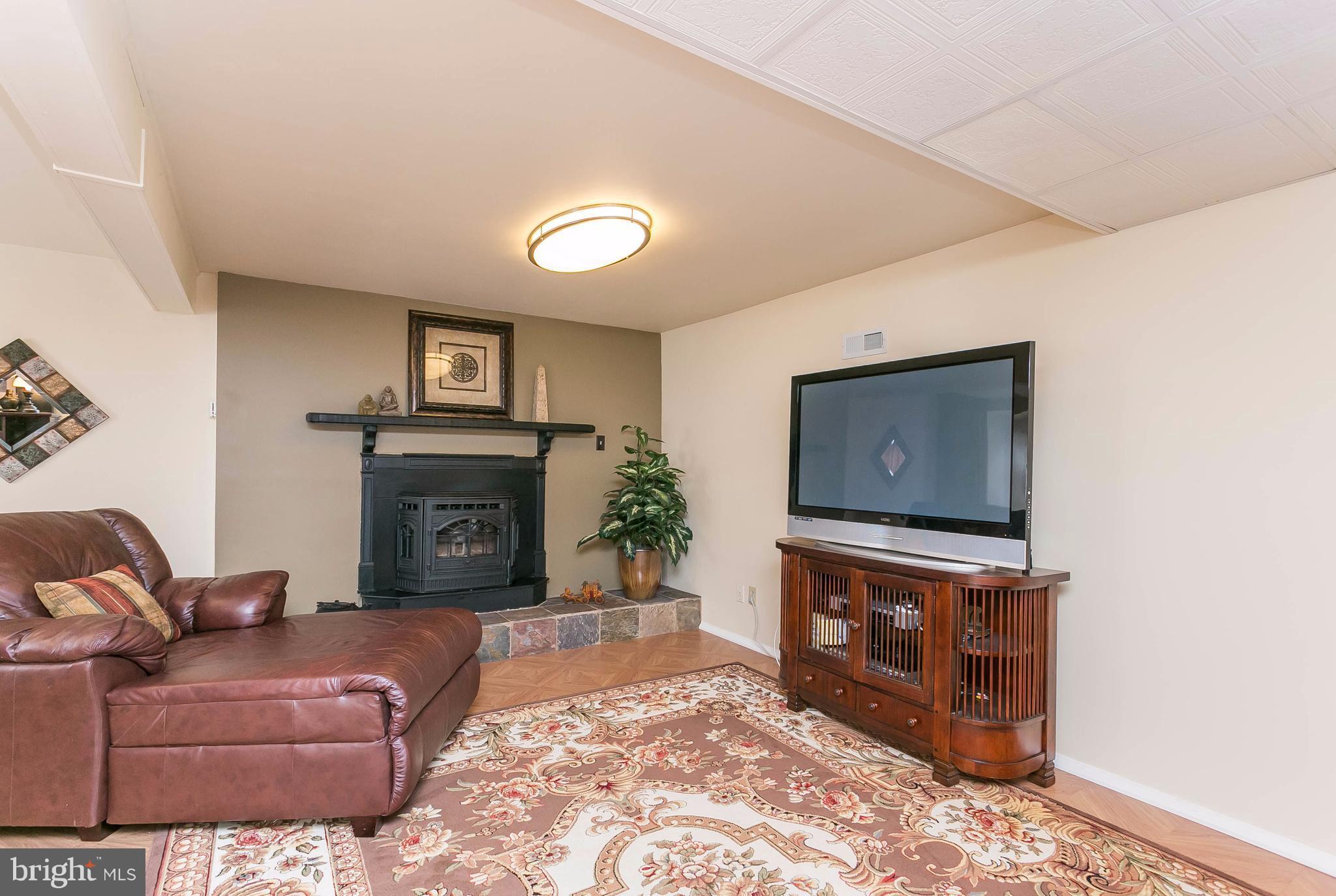 9421 Gunview Road Baltimore, MD 21236 - Photo 20 of 30 Finished lower level with pellet stove insert.