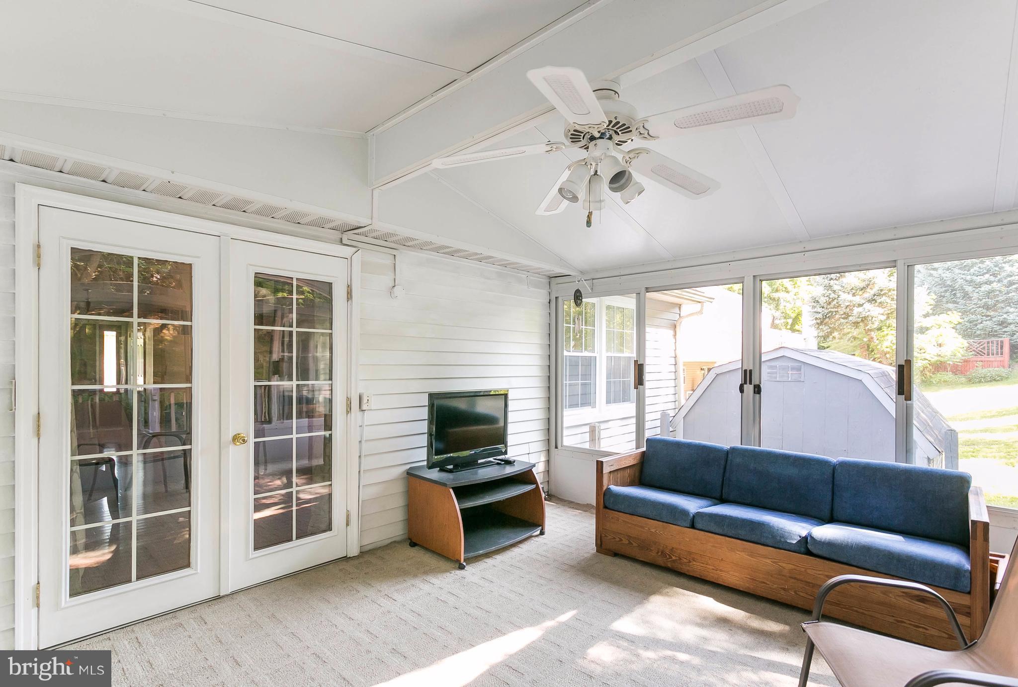 9421 Gunview Road Baltimore, MD 21236 - Photo 26 of 30 Patio enclosure with ceiling fan and carpet.