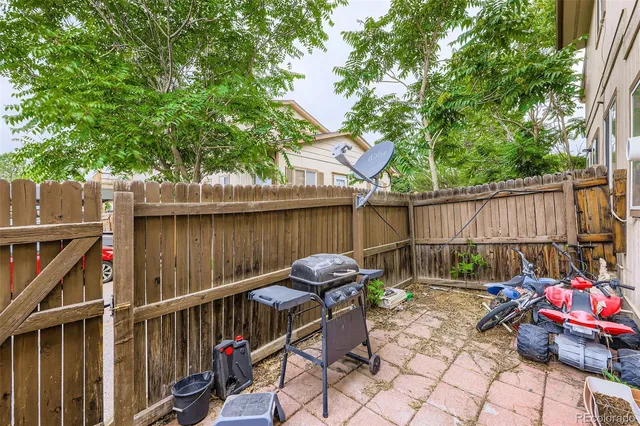 a view of a chairs and table in the back yard of the house