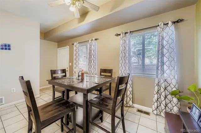 a view of a dining room with furniture and a window
