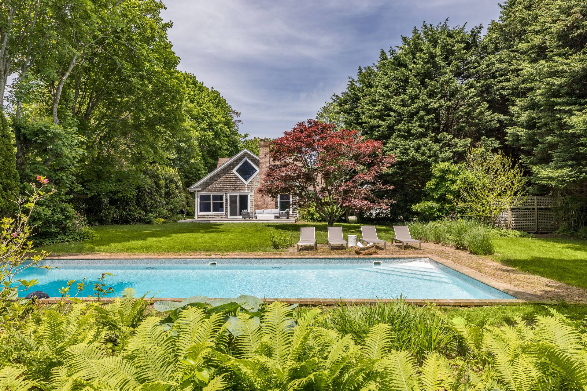 73 Accabonac Road East Hampton, NY 11937 - Photo 5 of 13 a view of a swimming pool with an outdoor space and seating area