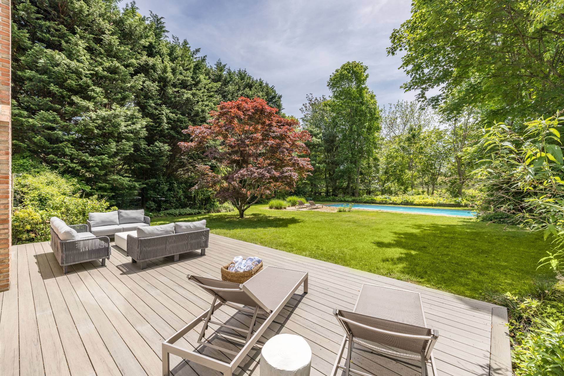 73 Accabonac Road East Hampton, NY 11937 - Photo 6 of 13 a view of a patio with couches table and chairs with plants and garden