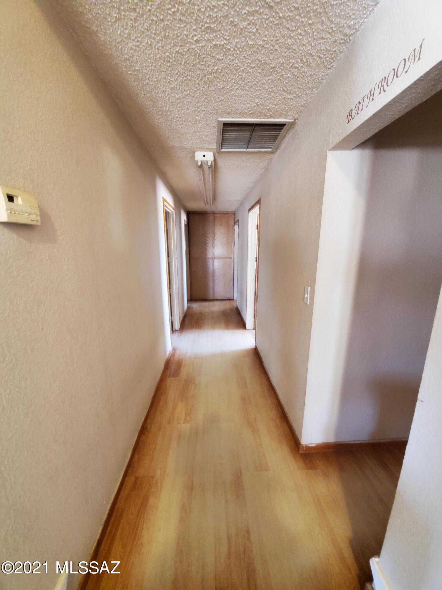 3440 East Howling Wolf Road Willcox, AZ 85643 - Photo 23 of 45 a view of a hallway with wooden floor