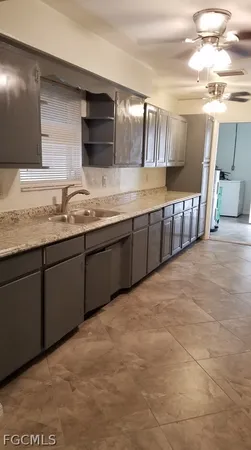 a spacious bathroom with stainless steel appliances granite countertop a sink and cabinets