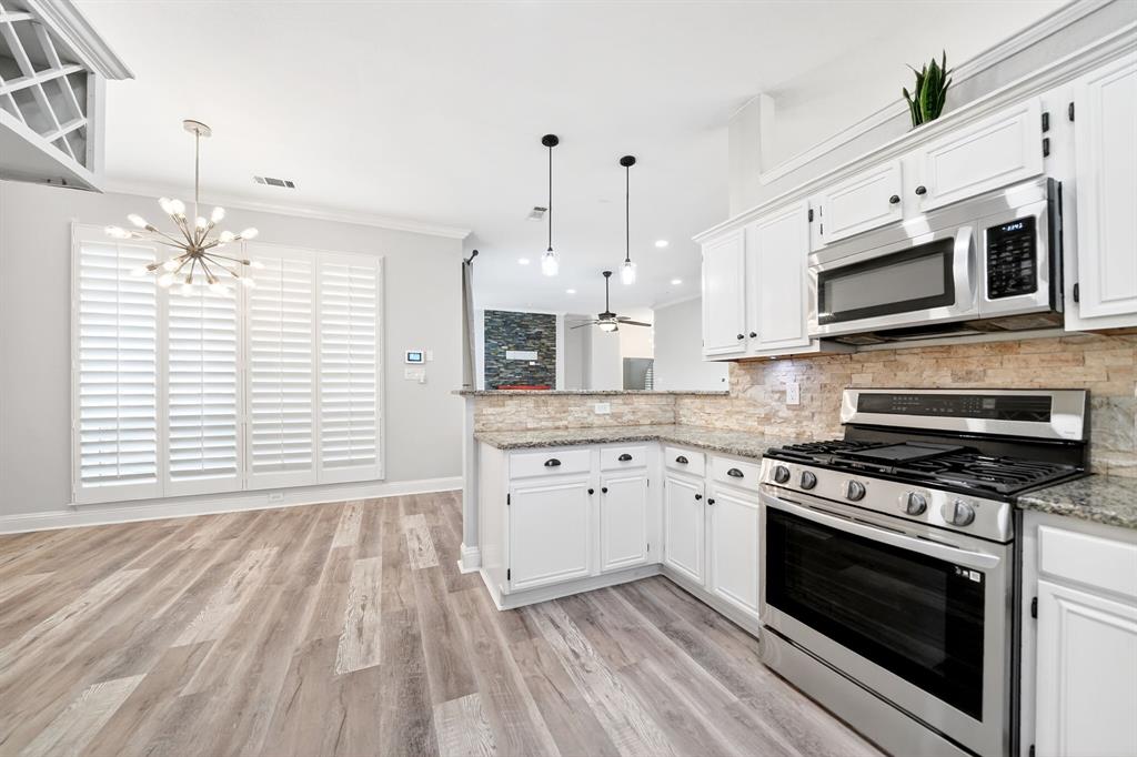 5618 Allen Lane Rowlett, TX 75088 - Photo 11 of 35 a kitchen with stainless steel appliances granite countertop a stove microwave and cabinets