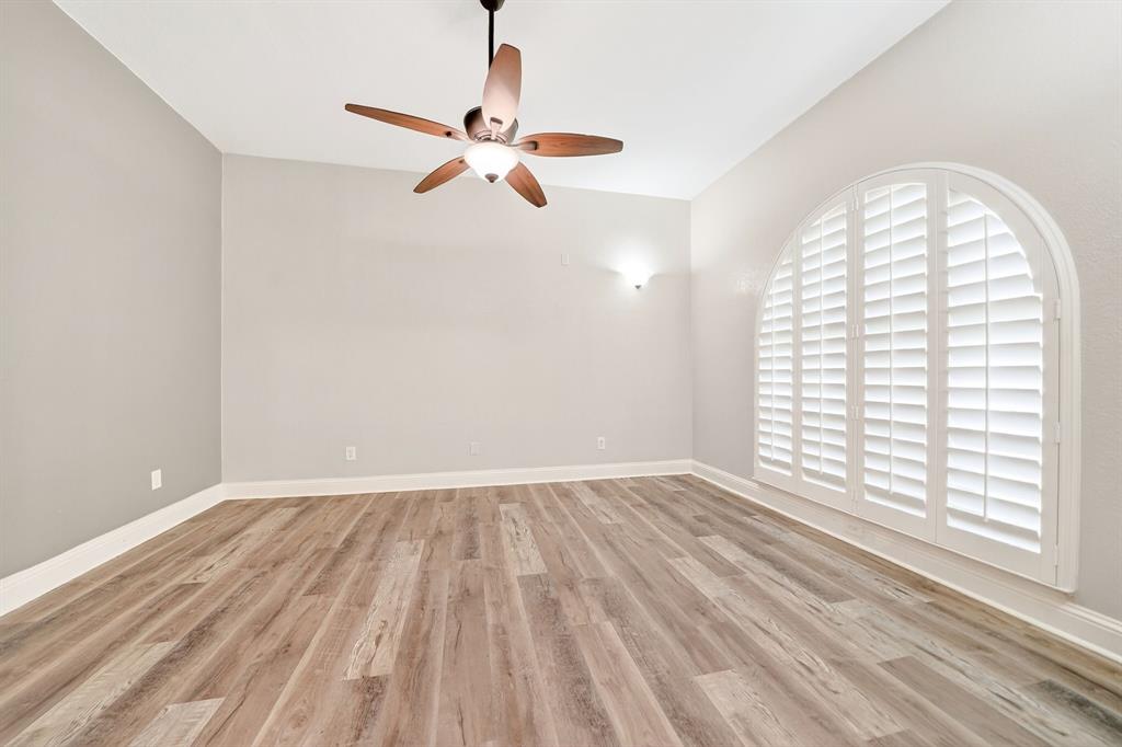 5618 Allen Lane Rowlett, TX 75088 - Photo 17 of 35 an empty room with wooden floor fan and windows