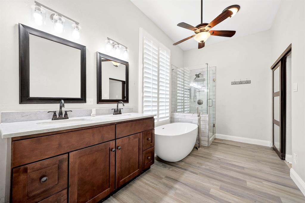 5618 Allen Lane Rowlett, TX 75088 - Photo 21 of 35 a spacious bathroom with a double vanity sink mirror and bathtub