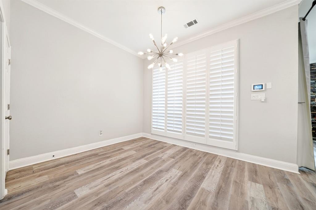 5618 Allen Lane Rowlett, TX 75088 - Photo 23 of 35 an empty room with wooden floor chandelier fan and windows