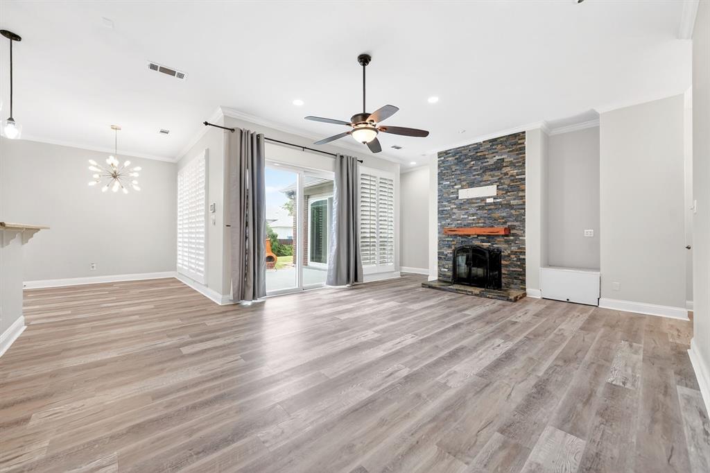 5618 Allen Lane Rowlett, TX 75088 - Photo 3 of 35 a view of empty room with wooden floor fireplace and a window