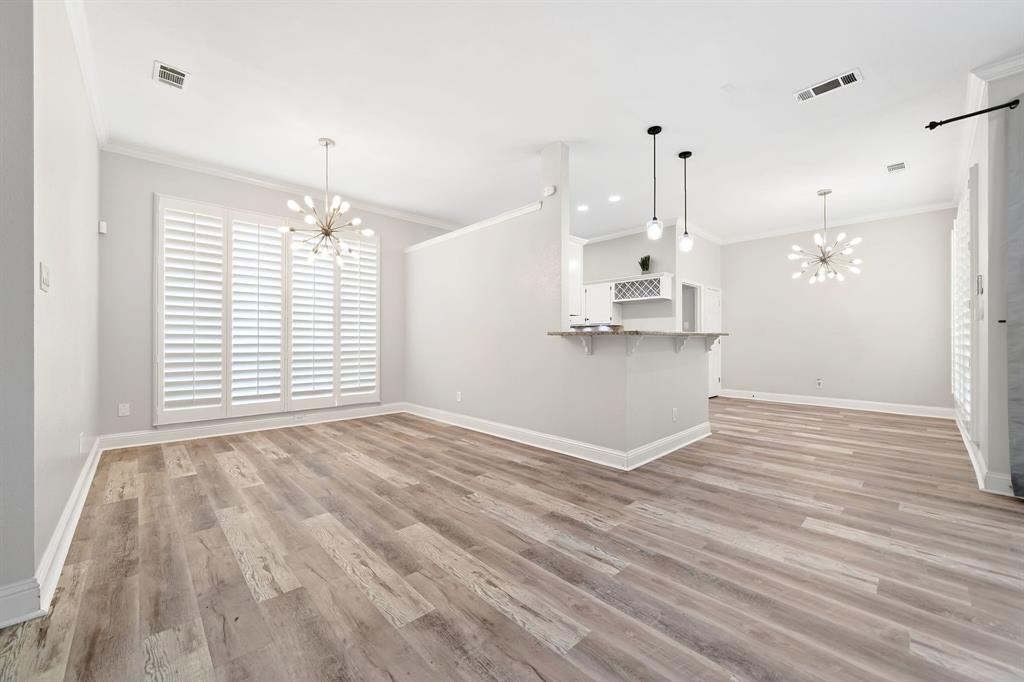 5618 Allen Lane Rowlett, TX 75088 - Photo 6 of 35 a view of a kitchen with kitchen island wooden floor stainless steel appliances and window