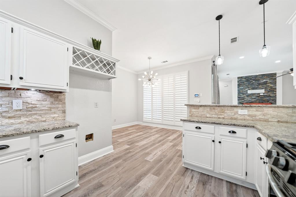 5618 Allen Lane Rowlett, TX 75088 - Photo 9 of 35 a kitchen with granite countertop a sink cabinets and wooden floor