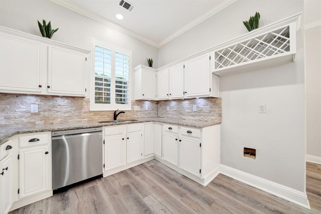 5618 Allen Lane Rowlett, TX 75088 - Photo 10 of 35 a kitchen with granite countertop white cabinets and white appliances
