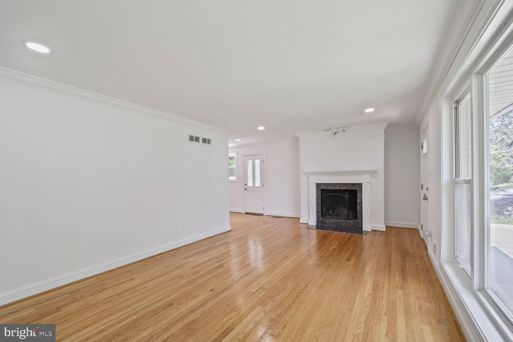 10213 Duvawn Place Silver Spring, MD 20902 - Photo 15 of 37 a view of an empty room with wooden floor and a window