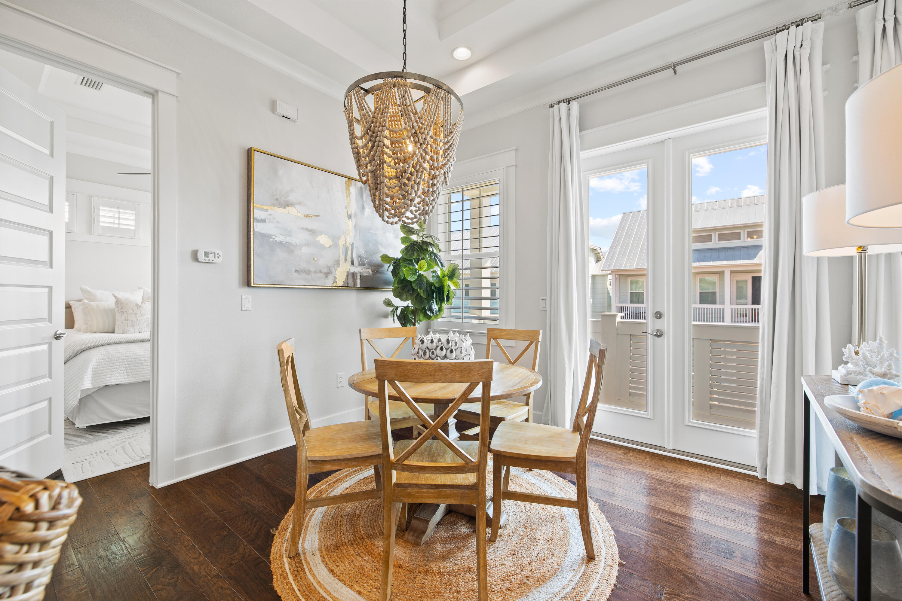 95 York Ln Inlet Beach, Unit C Inlet Beach, FL 32461 - Photo 18 of 36 a dining room with furniture a chandelier and wooden floor