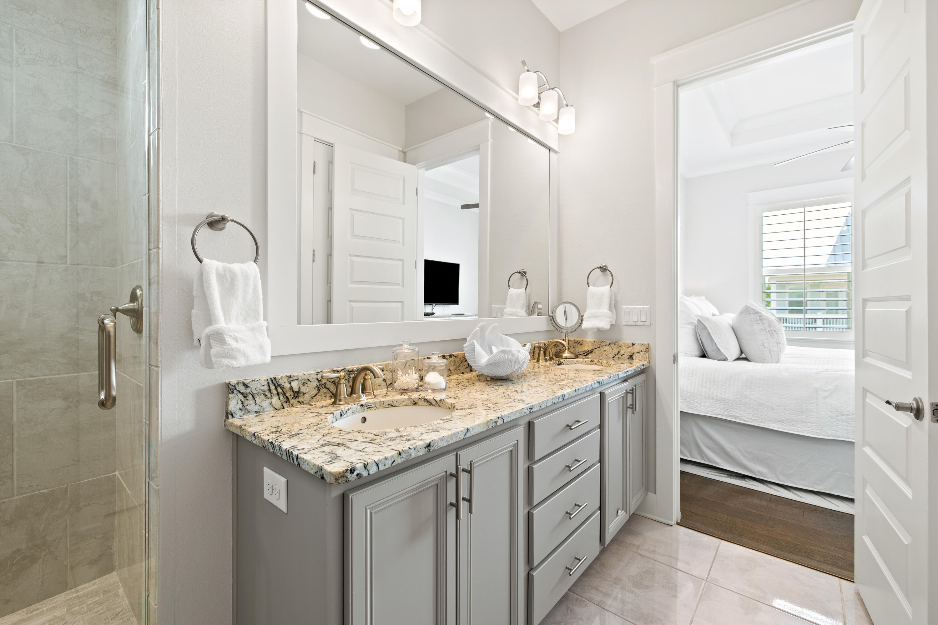 95 York Ln Inlet Beach, Unit C Inlet Beach, FL 32461 - Photo 23 of 36 a bathroom with a granite countertop sink and a mirror