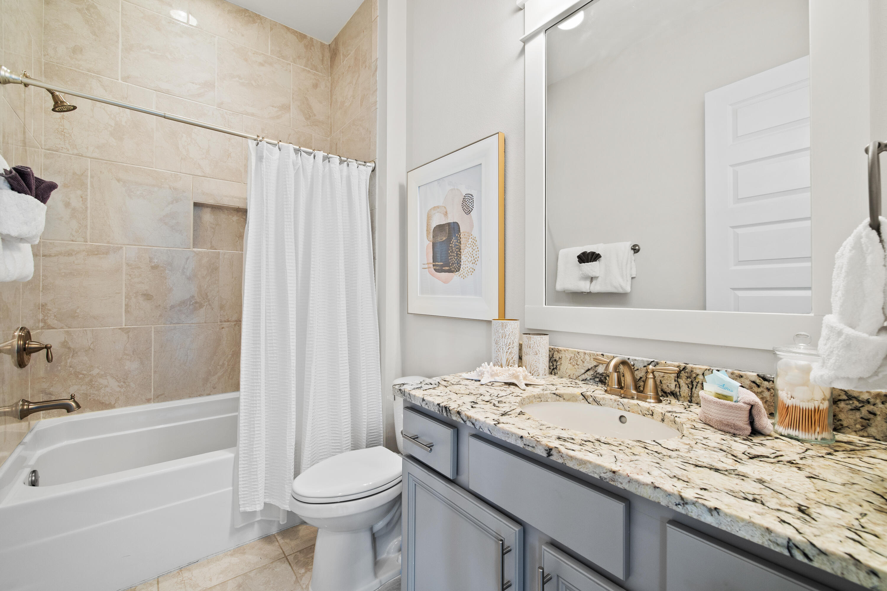 95 York Ln Inlet Beach, Unit C Inlet Beach, FL 32461 - Photo 35 of 36 a bathroom with a granite countertop sink toilet and shower