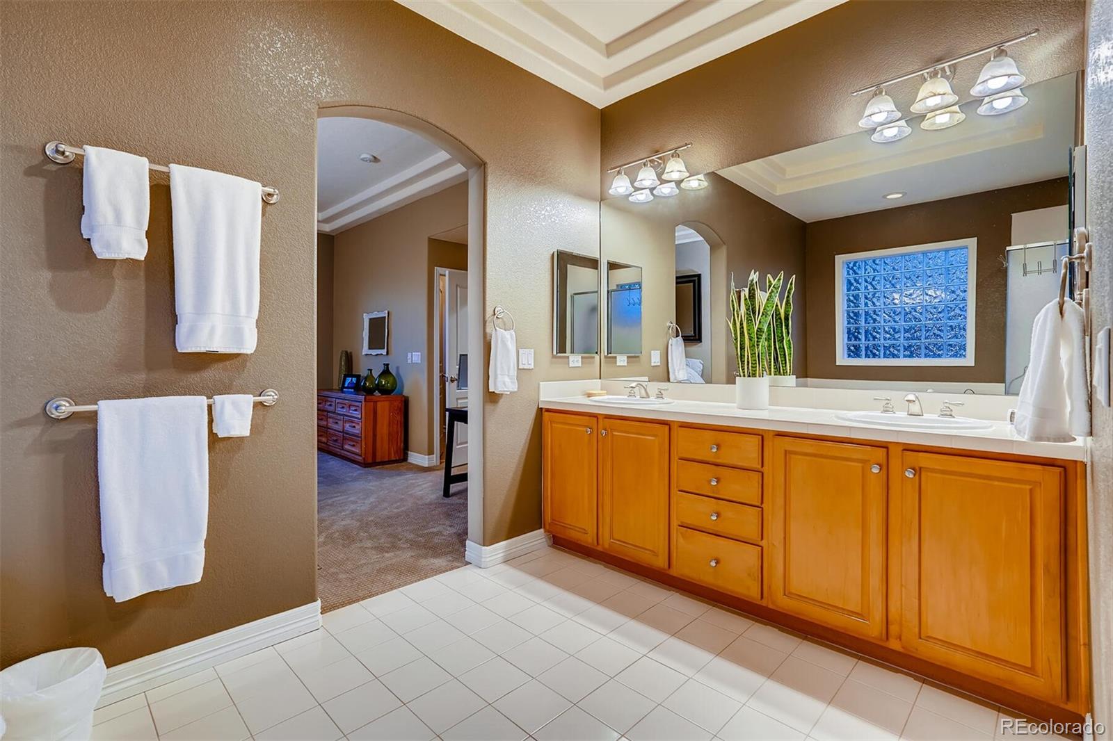 529 Uinta Way Denver, CO 80230 - Photo 17 of 40 a spacious bathroom with a sink double vanity granite and a mirror