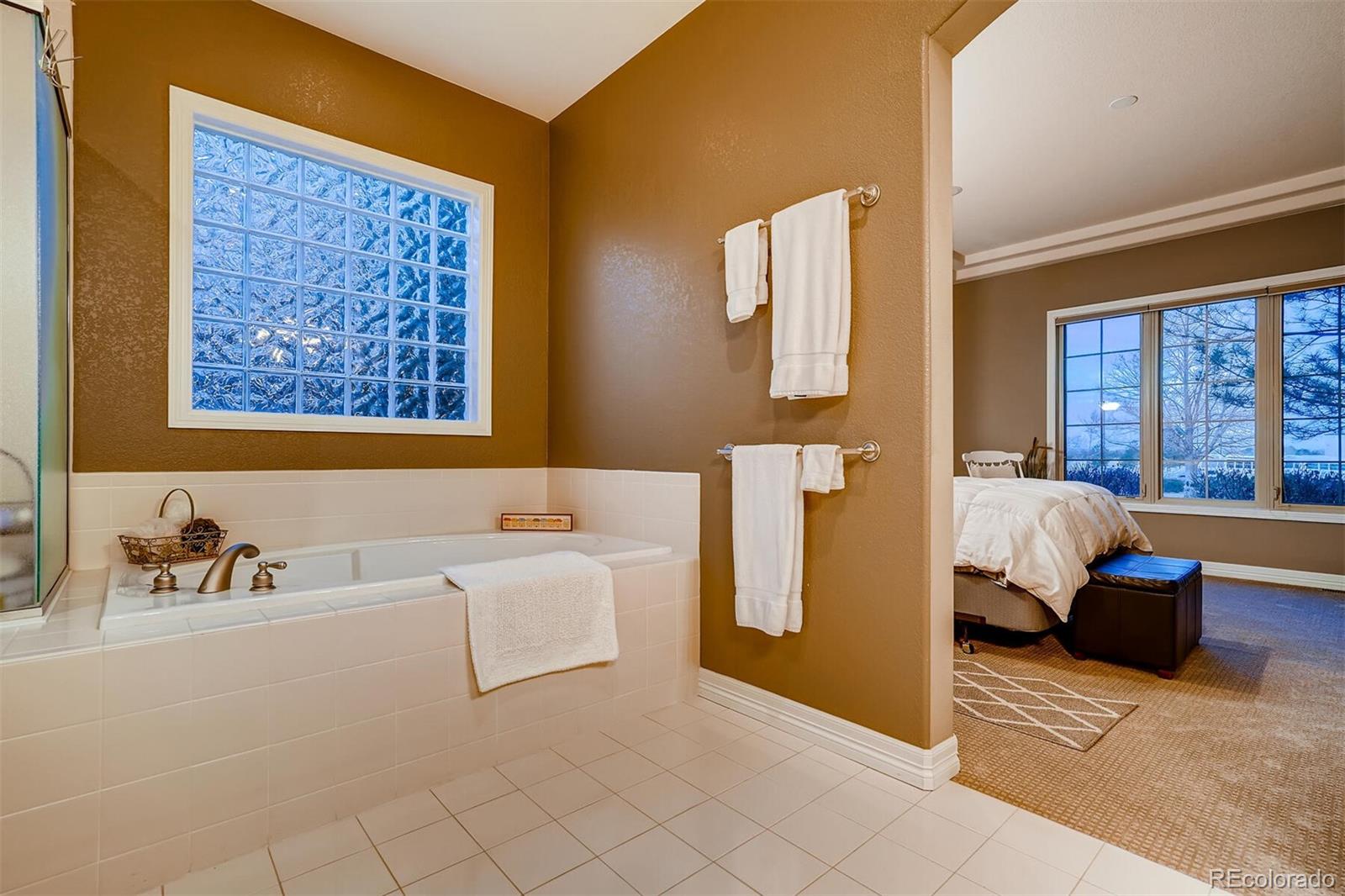 529 Uinta Way Denver, CO 80230 - Photo 18 of 40 a bathroom with a tub sink and mirror