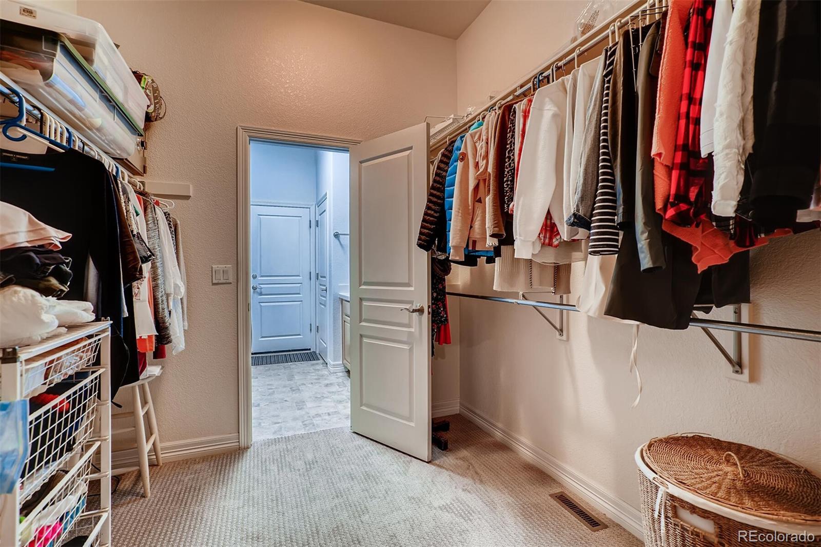 529 Uinta Way Denver, CO 80230 - Photo 19 of 40 a view of walk in closet with clothes and shoes