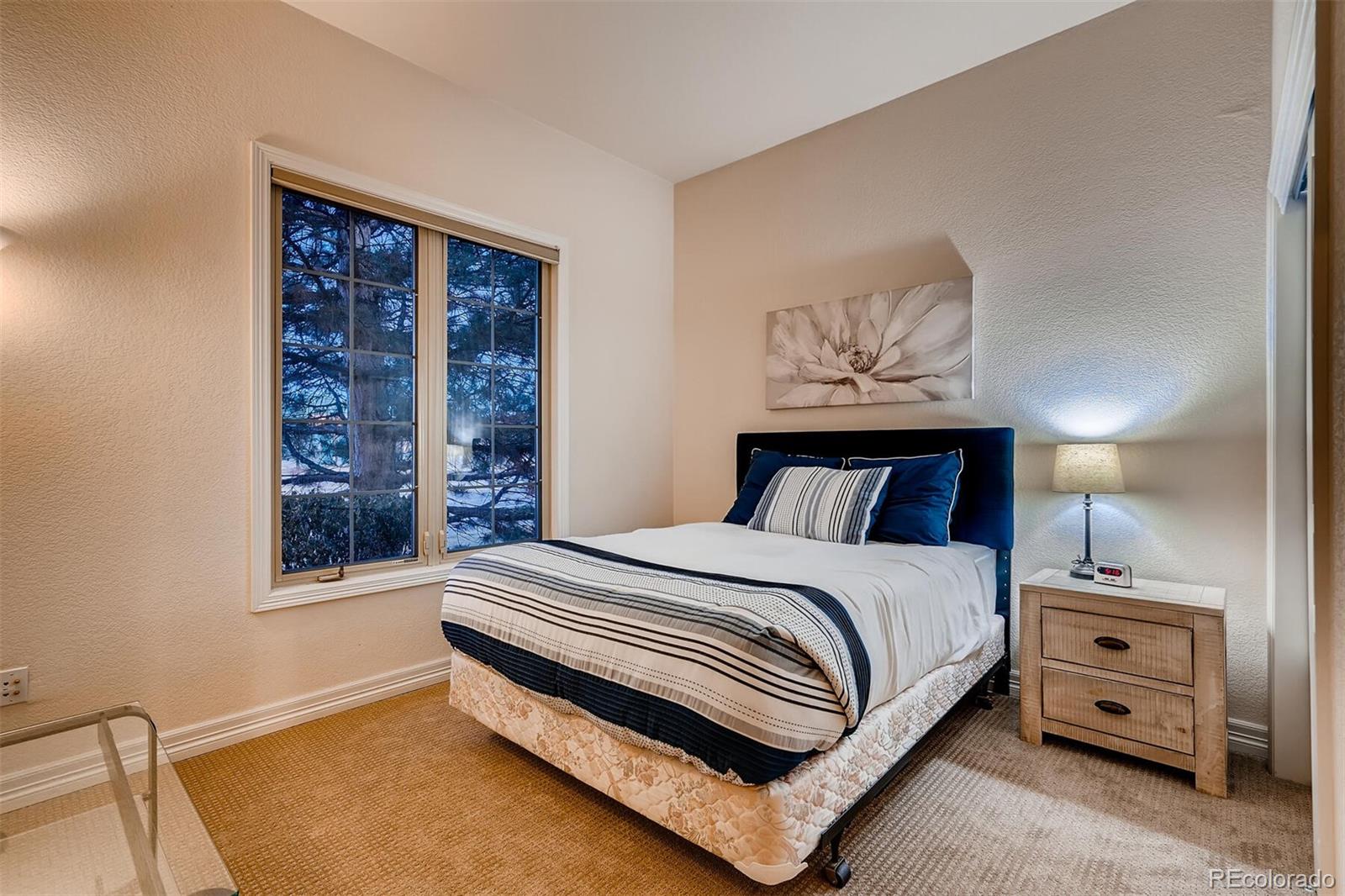 529 Uinta Way Denver, CO 80230 - Photo 20 of 40 a bedroom with a bed and a night stand