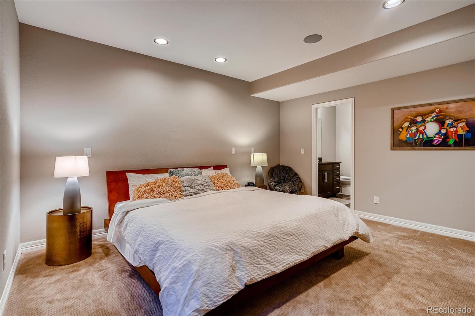 529 Uinta Way Denver, CO 80230 - Photo 30 of 40 a bedroom with a large bed and a painting on the wall