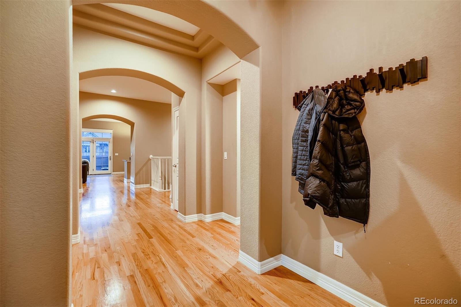 529 Uinta Way Denver, CO 80230 - Photo 3 of 40 a view of a hallway view with wooden floor and closet