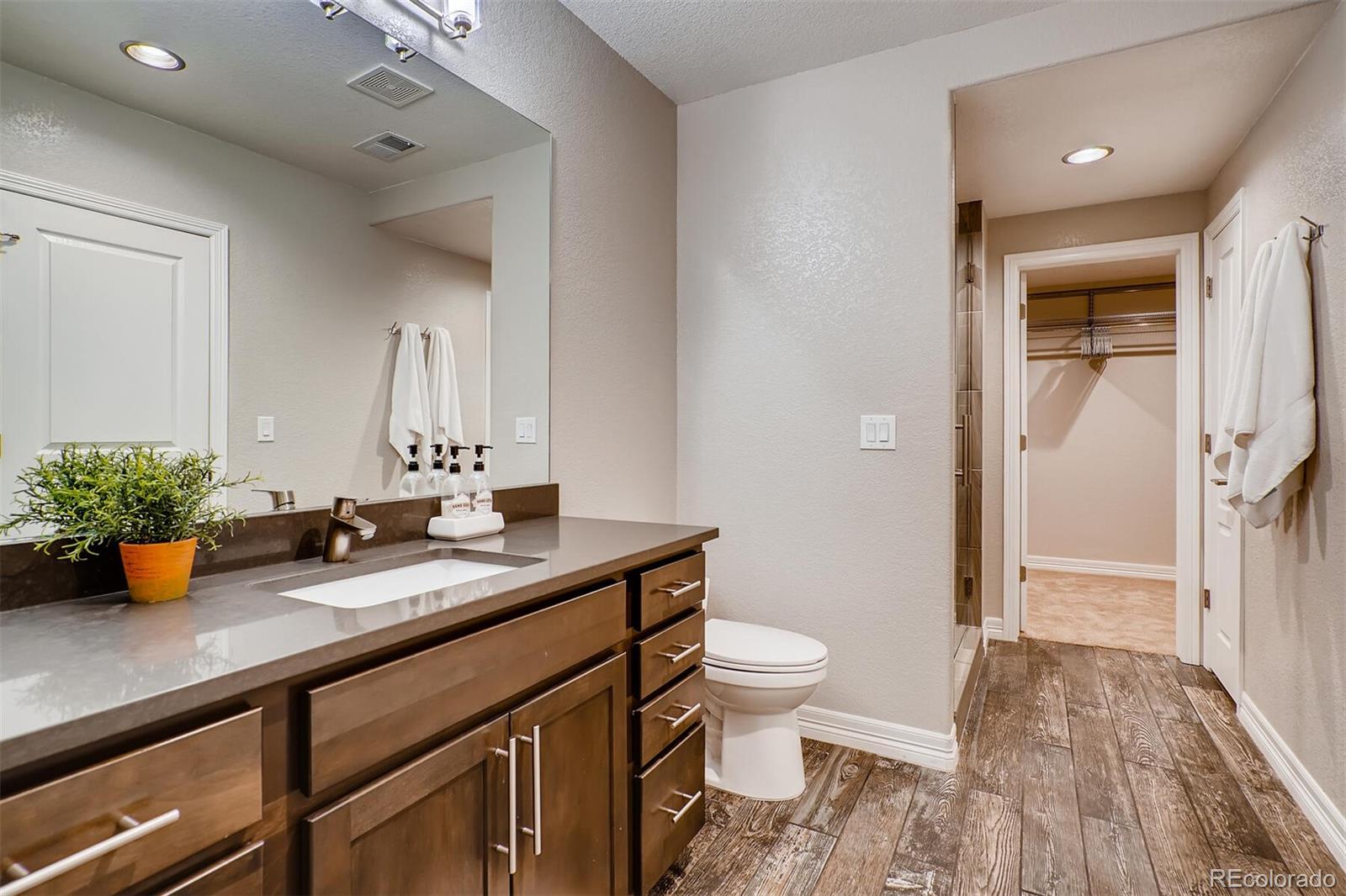 529 Uinta Way Denver, CO 80230 - Photo 31 of 40 a bathroom with a granite countertop sink and a mirror