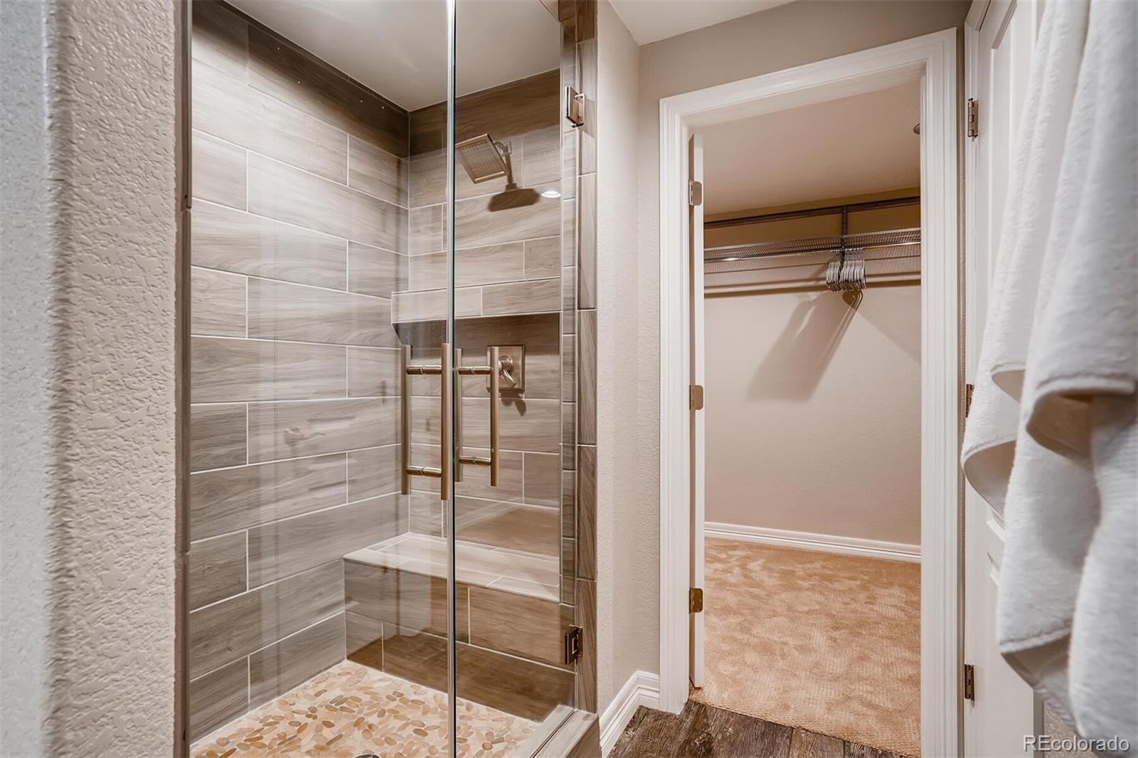 529 Uinta Way Denver, CO 80230 - Photo 32 of 40 a bathroom with a glass shower door