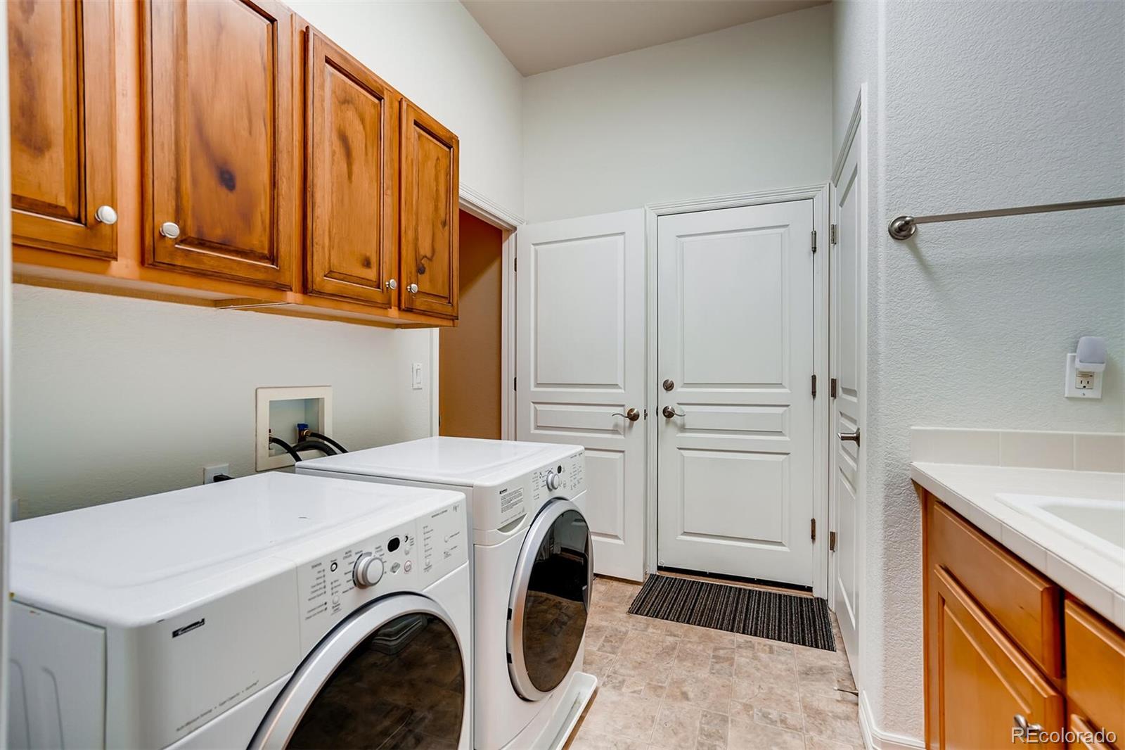 529 Uinta Way Denver, CO 80230 - Photo 37 of 40 a utility room with dryer and washer