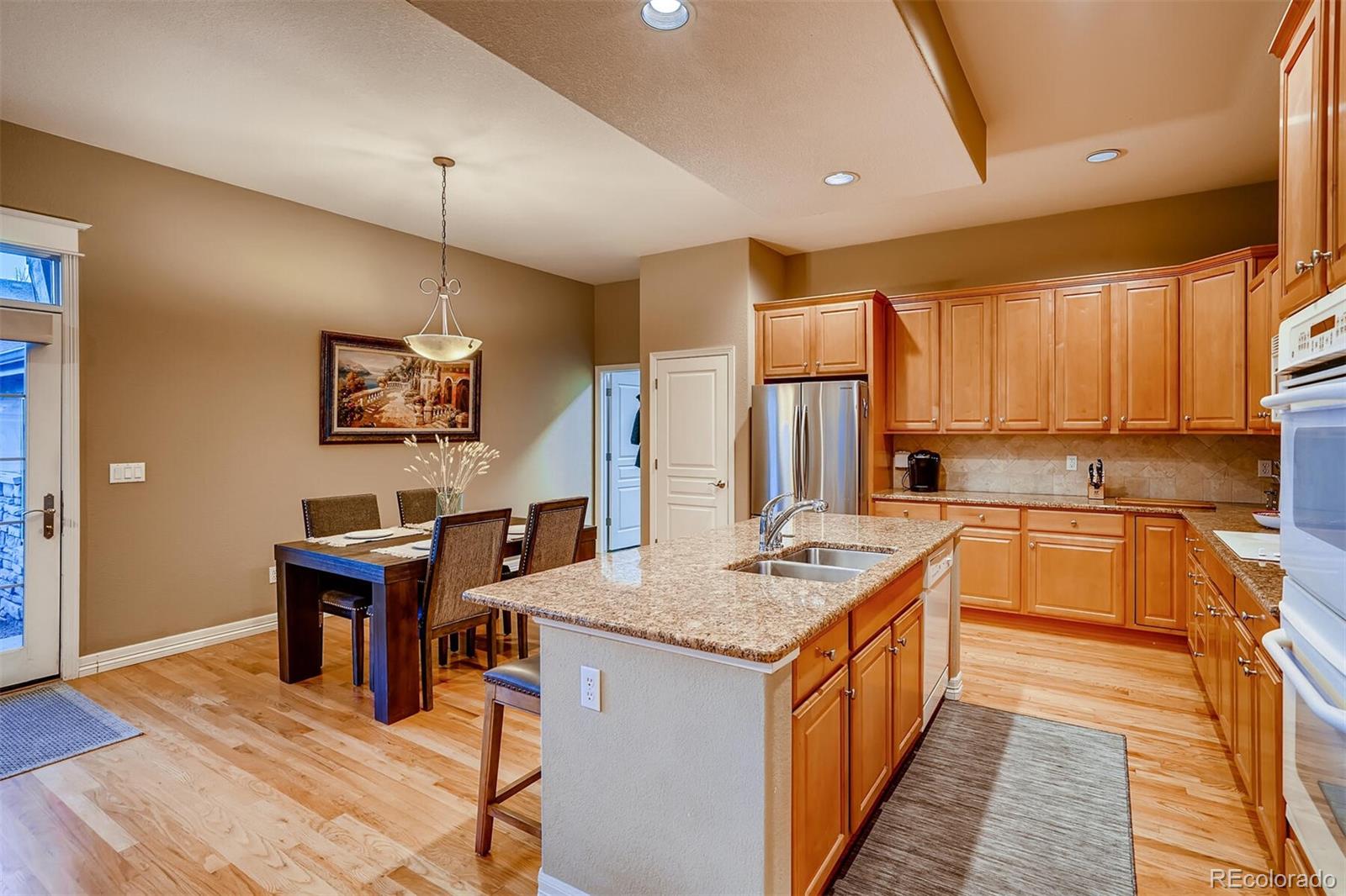 529 Uinta Way Denver, CO 80230 - Photo 8 of 40 a kitchen with a counter top space a sink appliances and cabinets