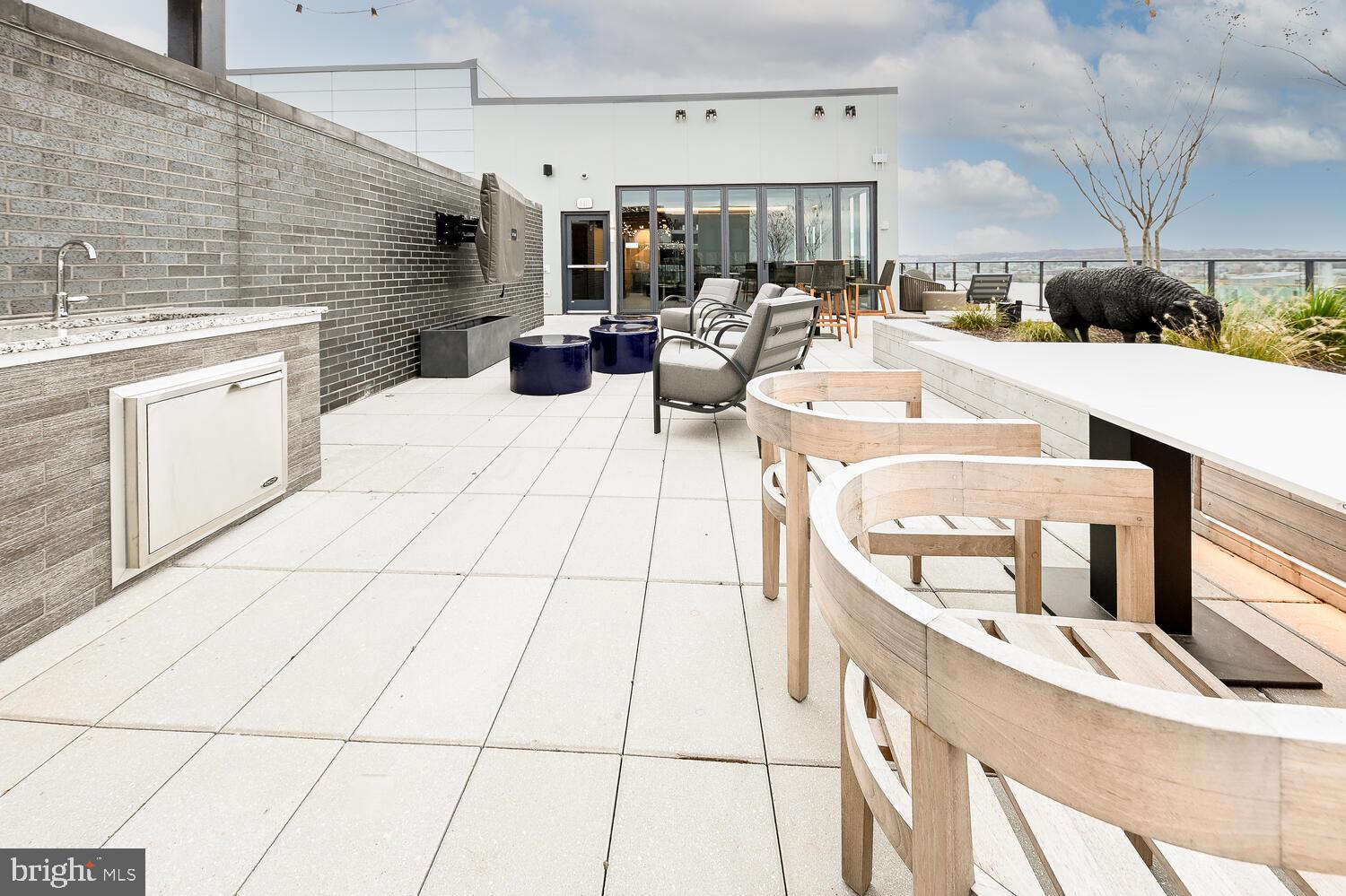 a living room with stainless steel appliances kitchen island granite countertop a sink and cabinets