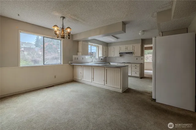 a view of a kitchen with a sink cabinets and wooden floor