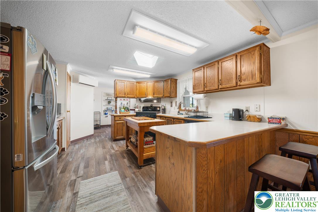 6149 Snyders Church Road, Unit TRL#28 Bath, PA 18014 - Photo 11 of 43 a kitchen with stainless steel appliances granite countertop a sink stove and refrigerator