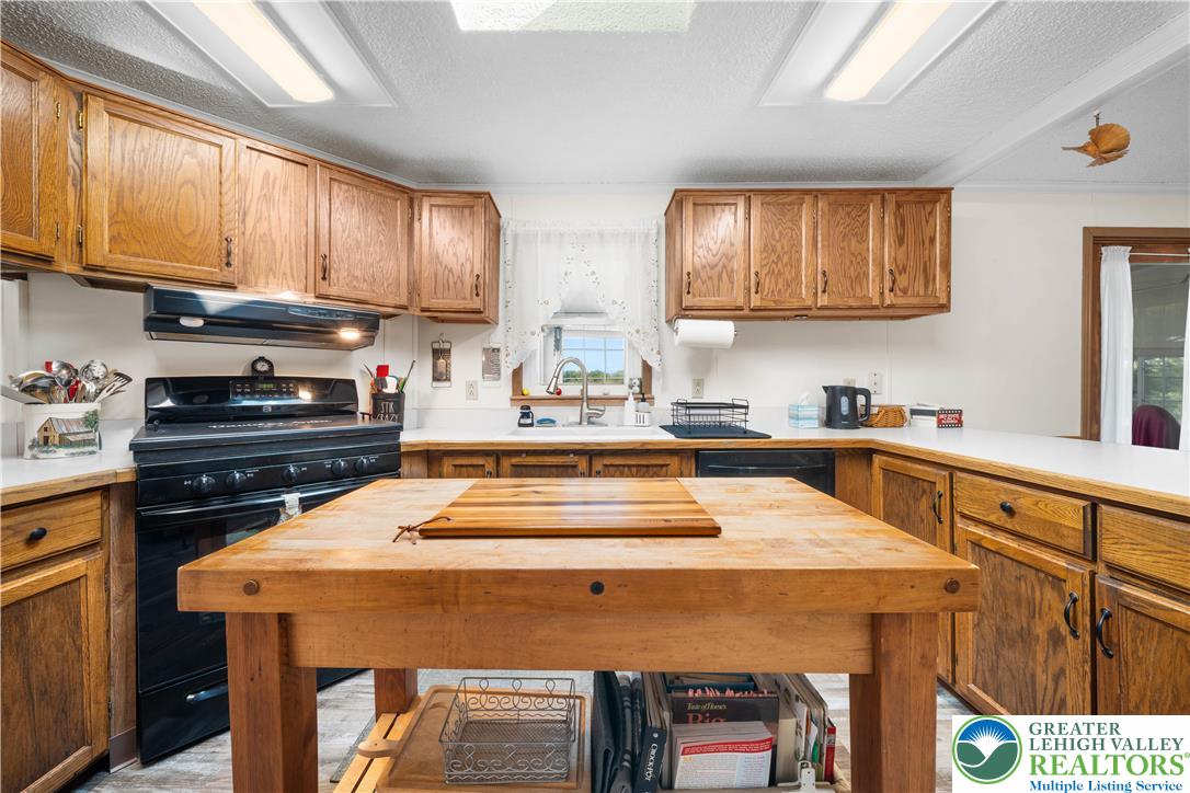 6149 Snyders Church Road, Unit TRL#28 Bath, PA 18014 - Photo 12 of 43 a kitchen with a sink a stove and cabinets