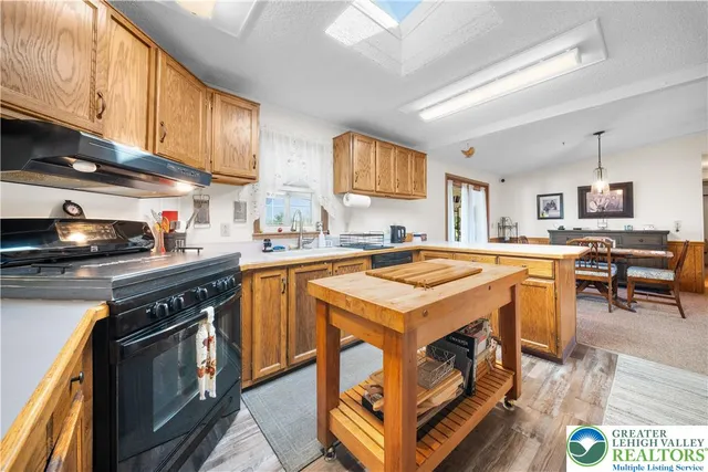 a kitchen with a sink a stove and cabinets