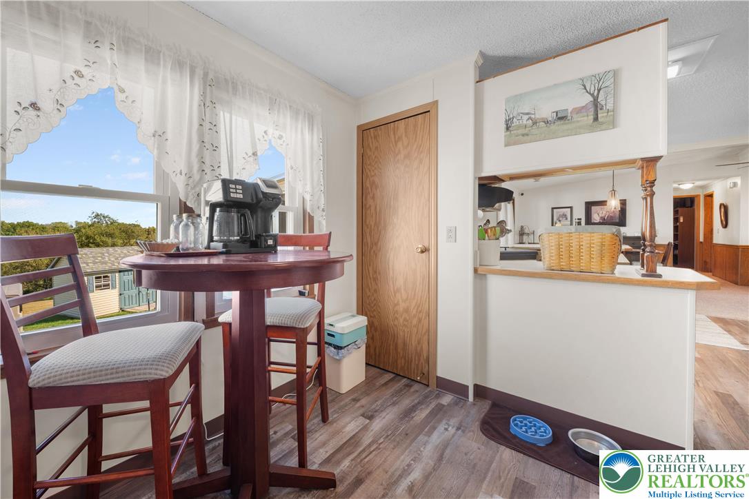 6149 Snyders Church Road, Unit TRL#28 Bath, PA 18014 - Photo 15 of 43 a view of a dining room with furniture and wooden floor