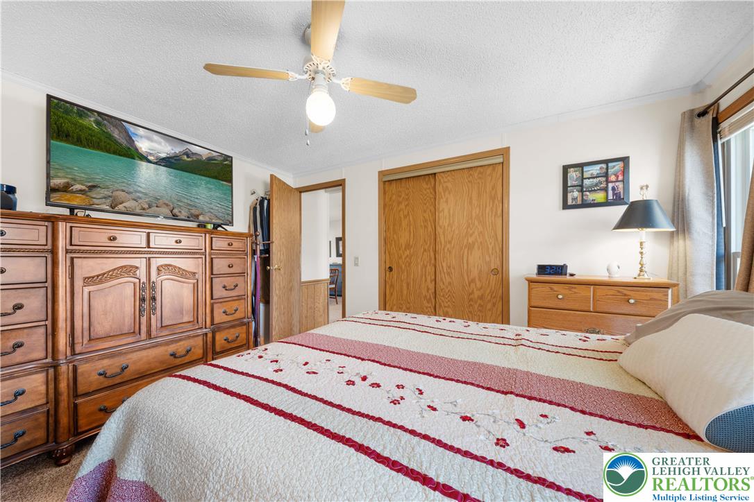 6149 Snyders Church Road, Unit TRL#28 Bath, PA 18014 - Photo 17 of 43 a bedroom with furniture and flat screen tv