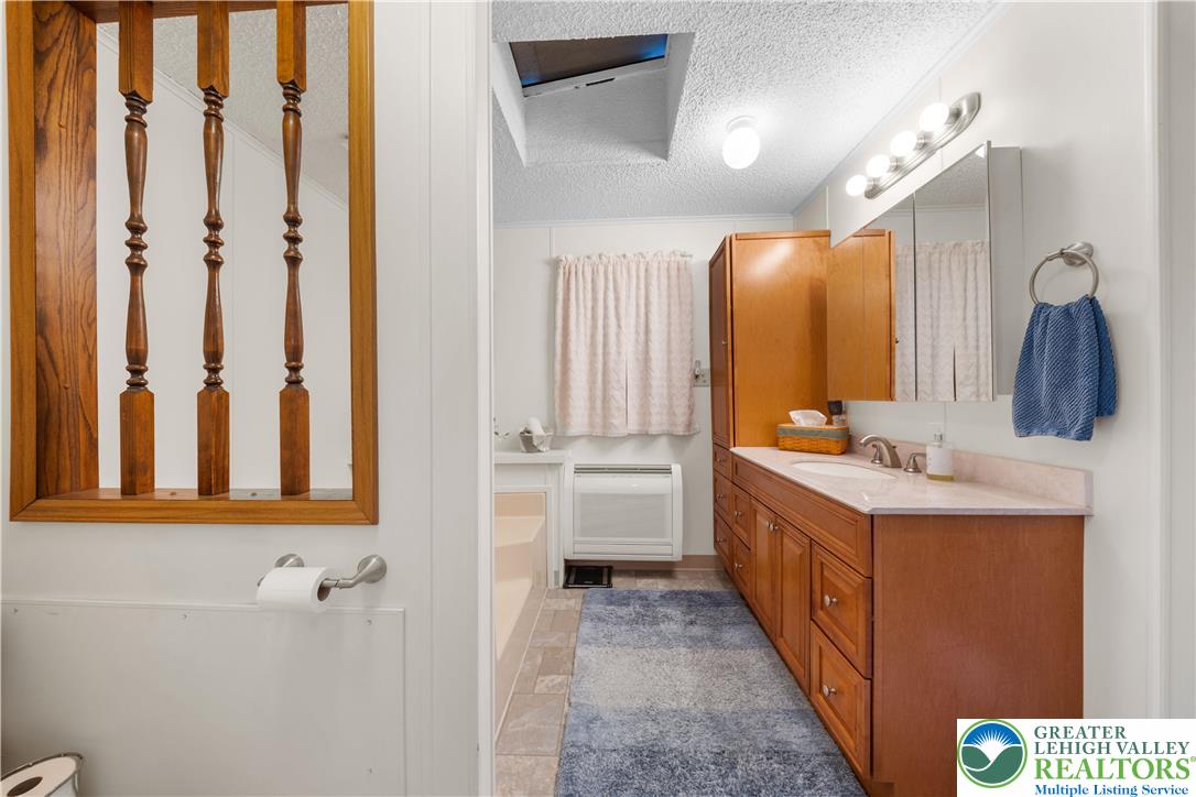 6149 Snyders Church Road, Unit TRL#28 Bath, PA 18014 - Photo 18 of 43 a bathroom with a double vanity sink mirror and