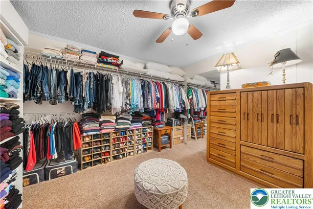 a view of walk in closet with clothes