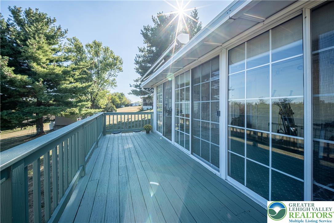 6149 Snyders Church Road, Unit TRL#28 Bath, PA 18014 - Photo 30 of 43 a view of balcony with wooden floor and fence