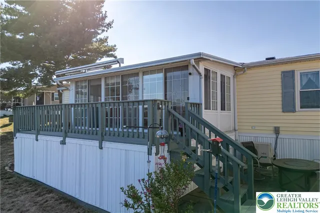 a view of a house with wooden fence