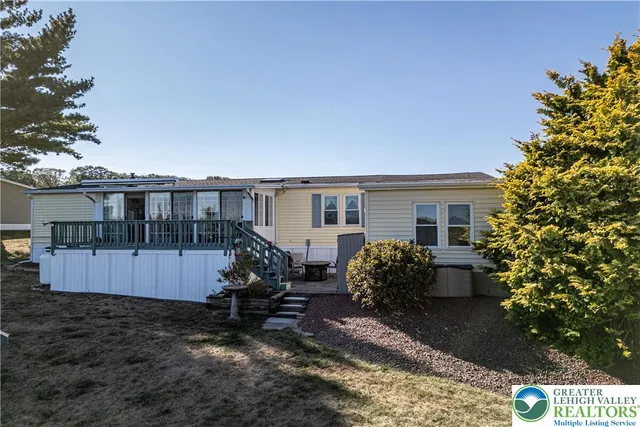 a view of a house with backyard and sitting area