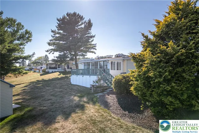 a view of a yard with plants and trees