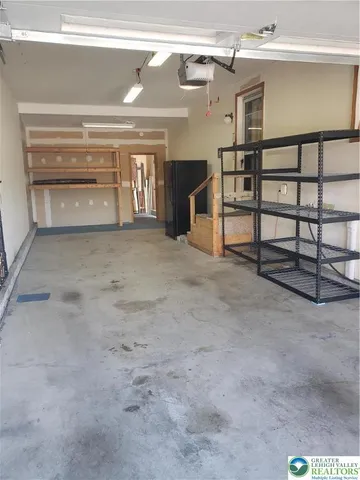 a room with stainless steel appliances lots of different kinds of food