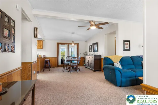 a living room with furniture and a dining table