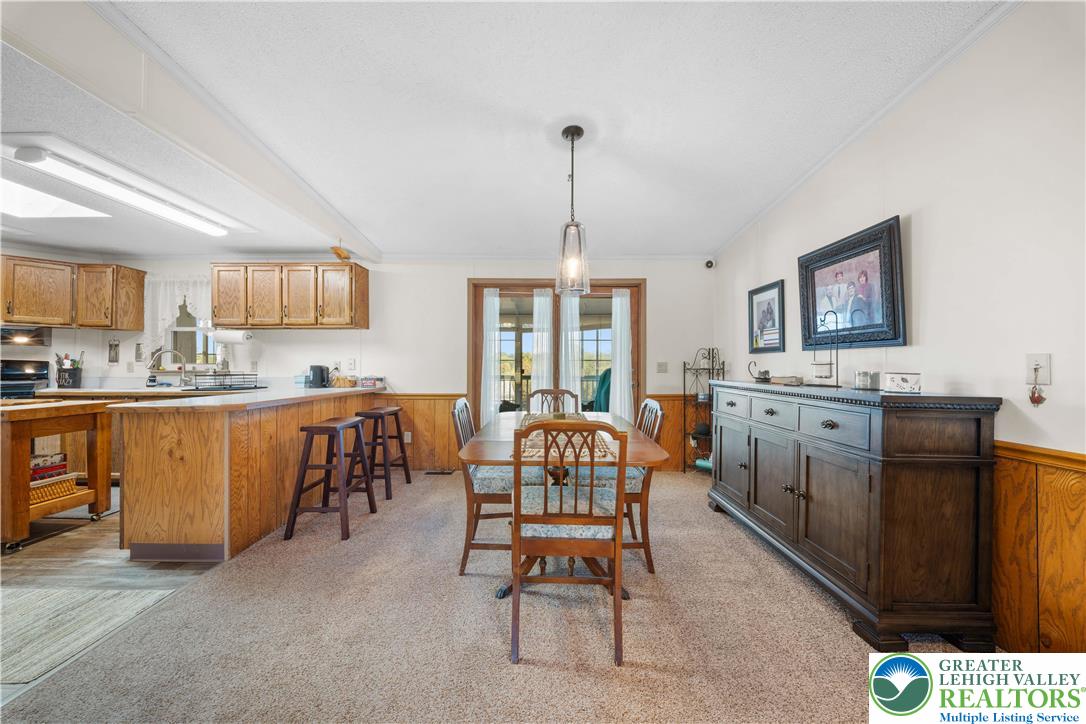 6149 Snyders Church Road, Unit TRL#28 Bath, PA 18014 - Photo 8 of 43 a living room with furniture a kitchen island and a window