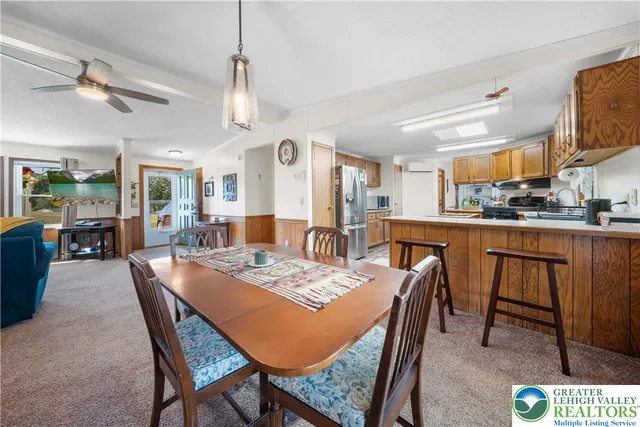 a dining room with a table chairs and kitchen view